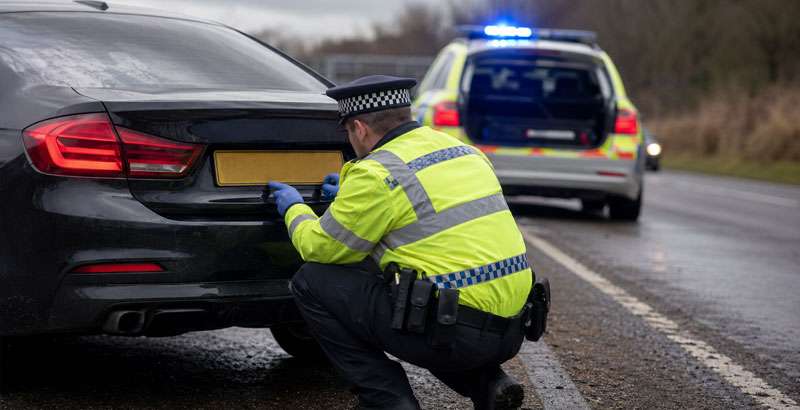 Police roadside check during DVLA number plate crackdown on illegal, cloned and ghost plates in the UK.